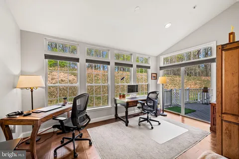 a view of a livingroom with workspace and a window