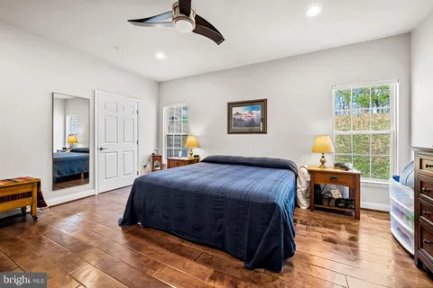 a bedroom with a bed a table and chair