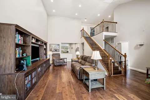 a living room with furniture wooden floor and a flat screen tv