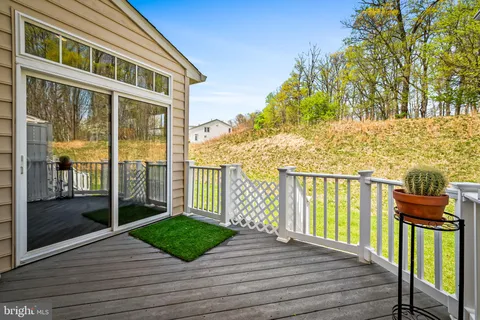 a view of a brick house with a yard table and chairs