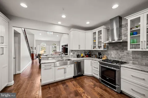 a kitchen with a sink stove and cabinets