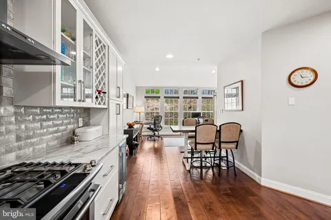 a kitchen with stove table and chairs