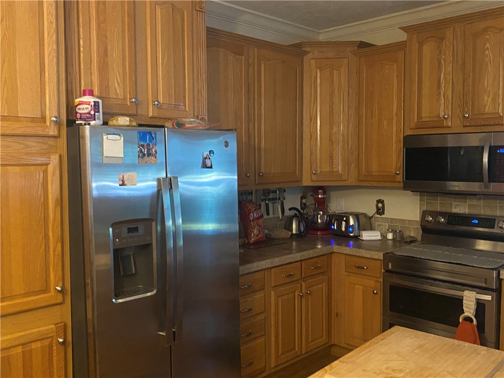 Classic oak cabinetry and matching crown molding define this kitchen.
