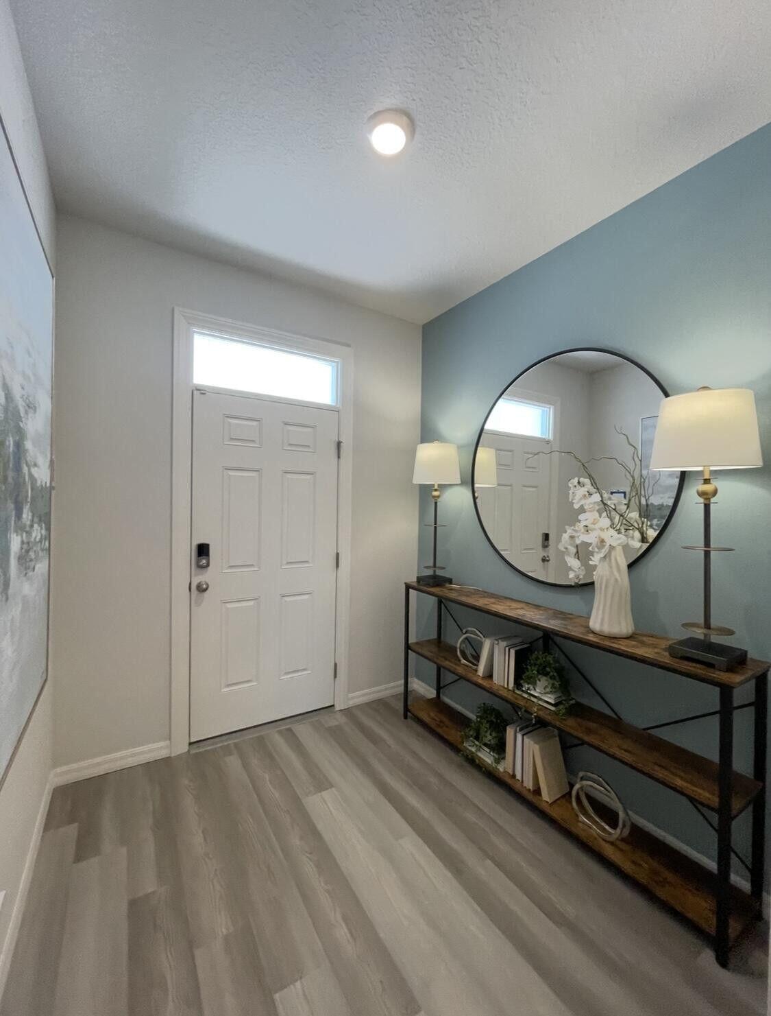 12901 Southwest Forli Way Port St. Lucie, FL 34987 - Photo 2 of 16 wooden floor with a mirror on a dresser