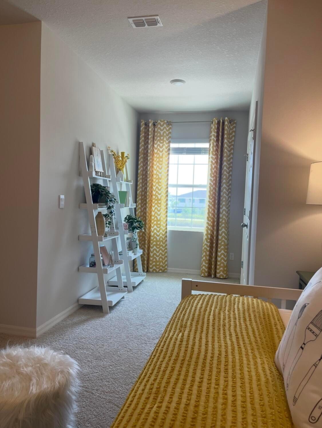 12901 Southwest Forli Way Port St. Lucie, FL 34987 - Photo 8 of 16 a view of a bedroom with workspace and a window
