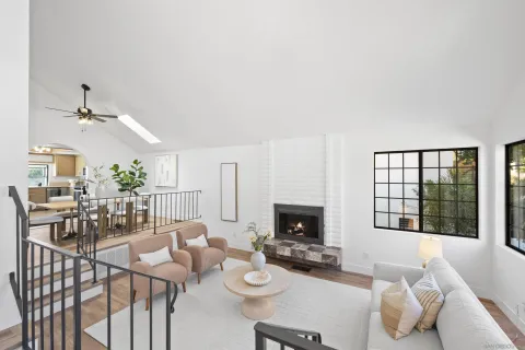 a living room with furniture a rug and white walls