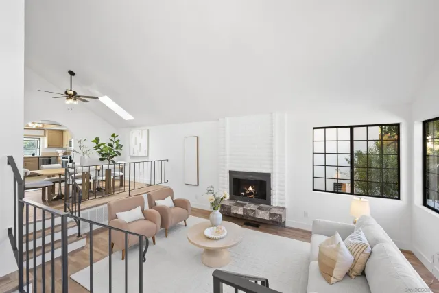 a living room with furniture a rug and white walls