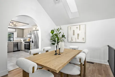 a view of a dining room with furniture and wooden floor