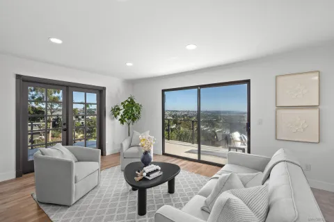 a kitchen with stainless steel appliances a stove a sink dishwasher a refrigerator cabinets and a dining table with wooden floor