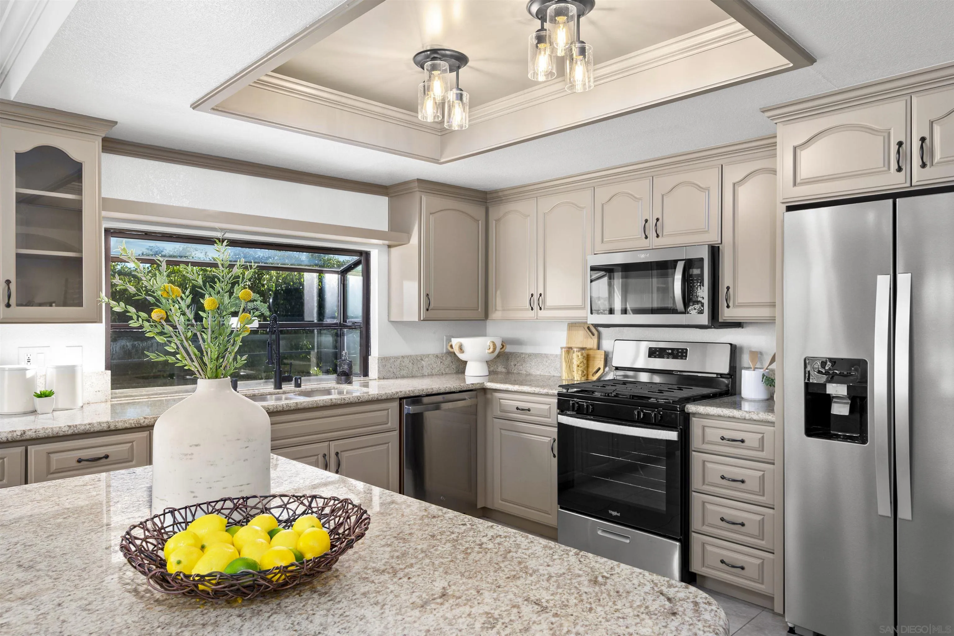 2431 Wilbur Avenue San Diego, CA 92109 - Photo 21 of 56 a kitchen with stainless steel appliances a stove a sink dishwasher a refrigerator cabinets and a dining table with wooden floor