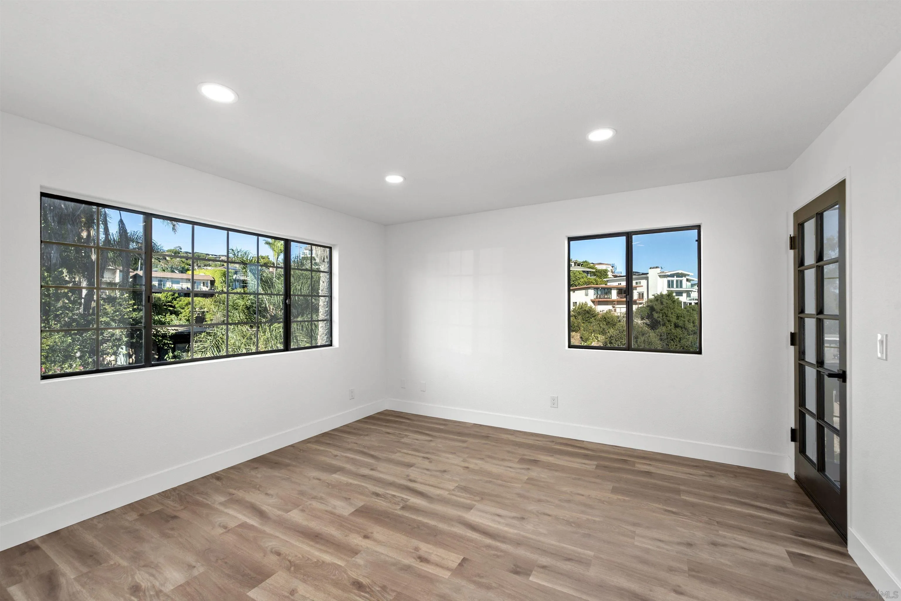 2431 Wilbur Avenue San Diego, CA 92109 - Photo 27 of 56 a view of an empty room with wooden floor and a window