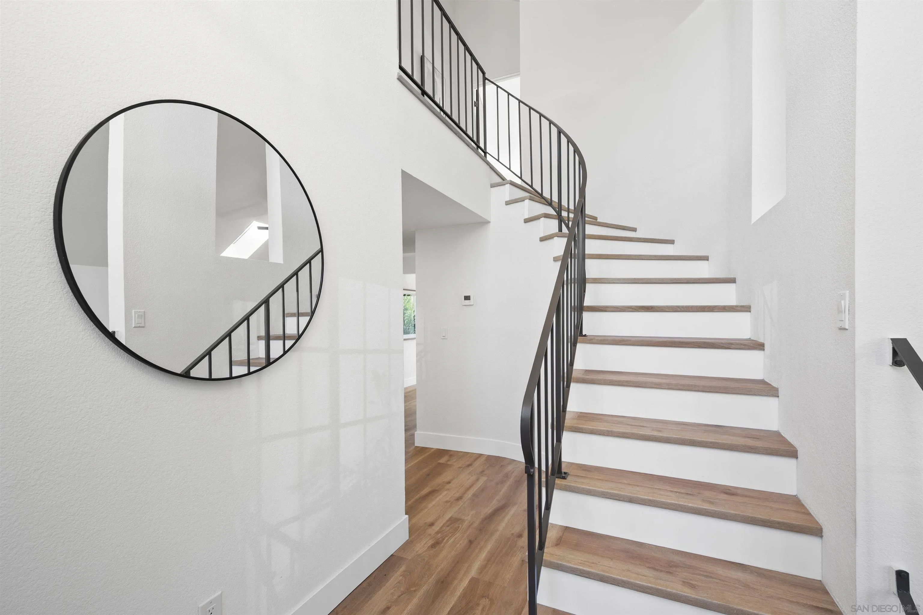 2431 Wilbur Avenue San Diego, CA 92109 - Photo 28 of 56 a view of staircase with white walls and a wooden floor