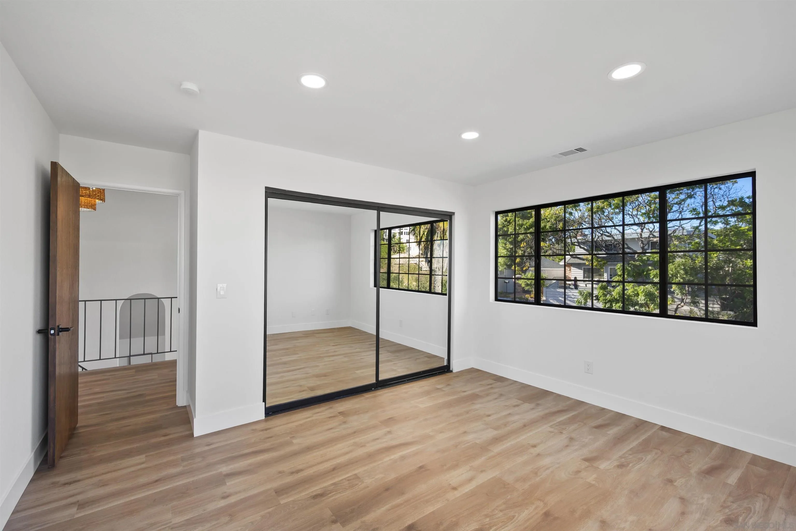2431 Wilbur Avenue San Diego, CA 92109 - Photo 30 of 56 a view of an empty room with wooden floor and a window