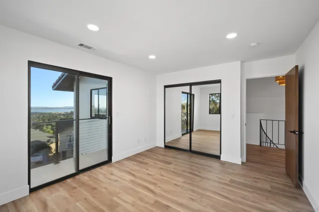 a bedroom with a large bed and a large window