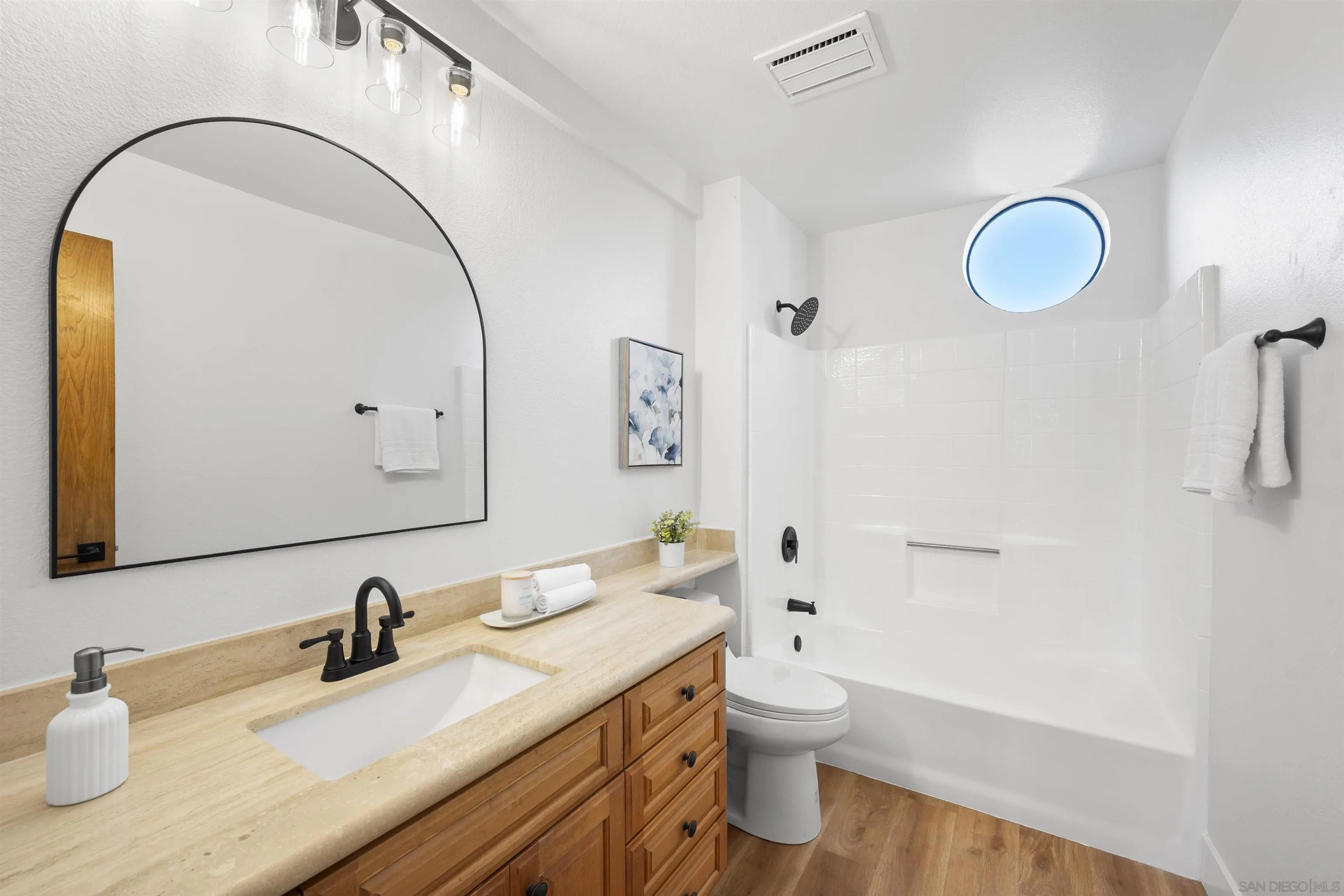 2431 Wilbur Avenue San Diego, CA 92109 - Photo 32 of 56 a bathroom with a granite countertop sink mirror vanity and toilet