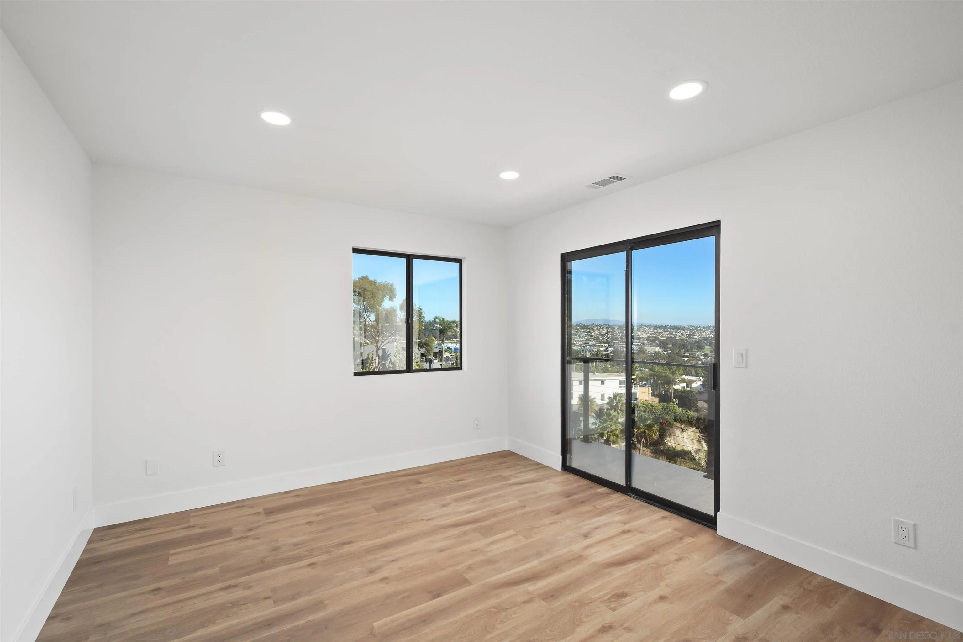 2431 Wilbur Avenue San Diego, CA 92109 - Photo 33 of 56 an empty room with wooden floor and windows