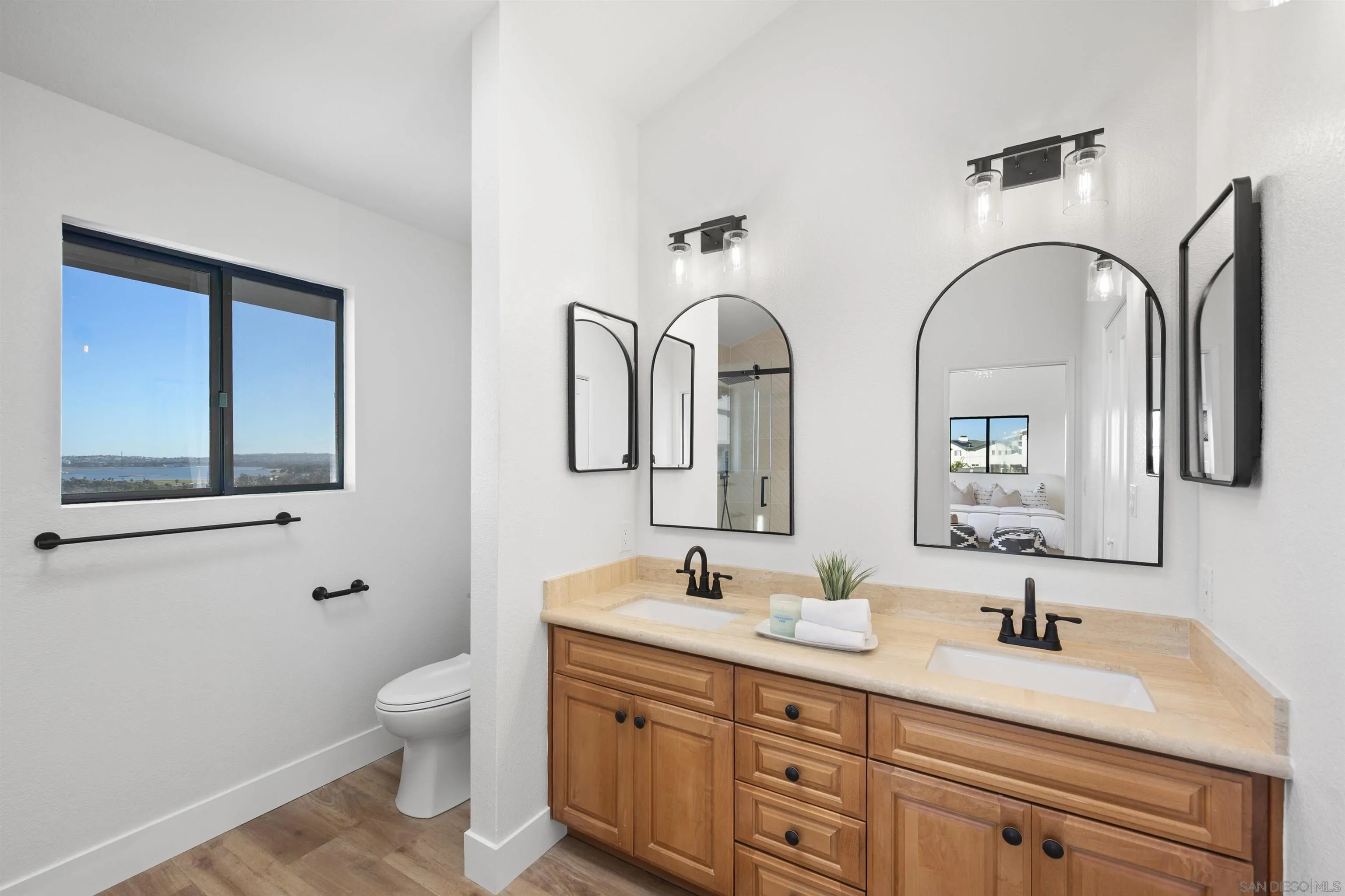 2431 Wilbur Avenue San Diego, CA 92109 - Photo 38 of 56 a bathroom with 2 sink toilet and a mirror