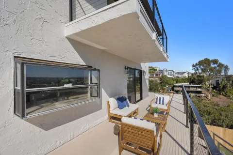 a view of a house with backyard porch and sitting area