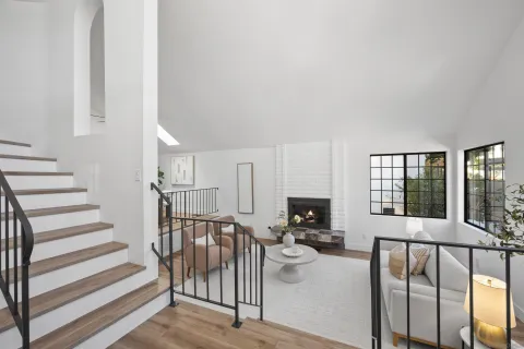 a view of a hallway with wooden floor and stairs