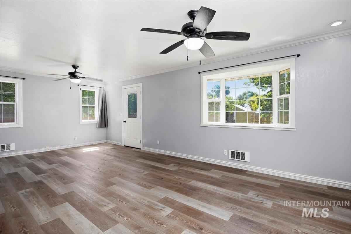 1940 Q Street Heyburn, ID 83336 - Photo 5 of 30 Spacious interior featuring wood-finish flooring, light gray walls, and crown molding