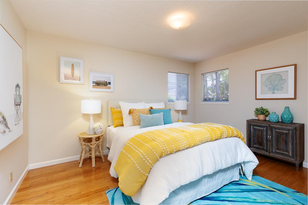 771 Seacliff Drive Aptos, CA 95003 - Photo 9 of 26 a bedroom with a bed and wooden floor