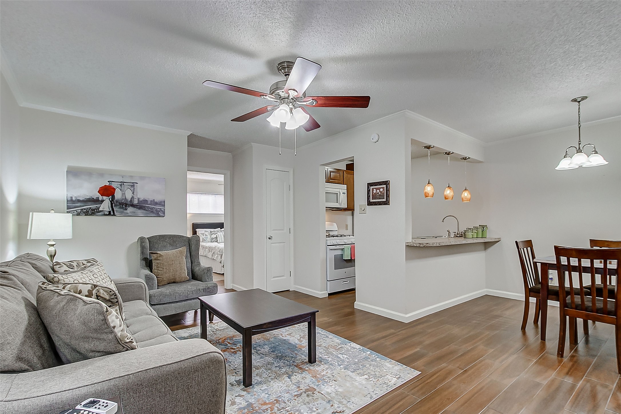 4727 West Alabama Street, Unit 1101 Houston, TX 77027 - Photo 2 of 8 a living room with furniture and wooden floor