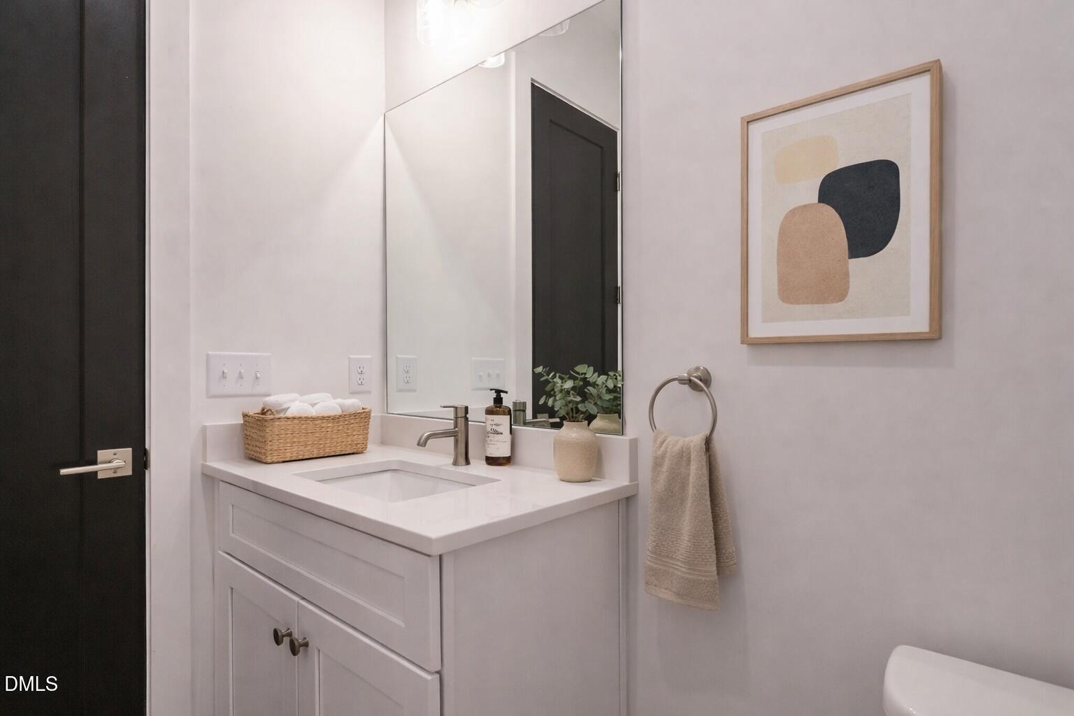 1521 Havenmont Court Raleigh, NC 27608 - Photo 22 of 36 a bathroom with a sink and a mirror