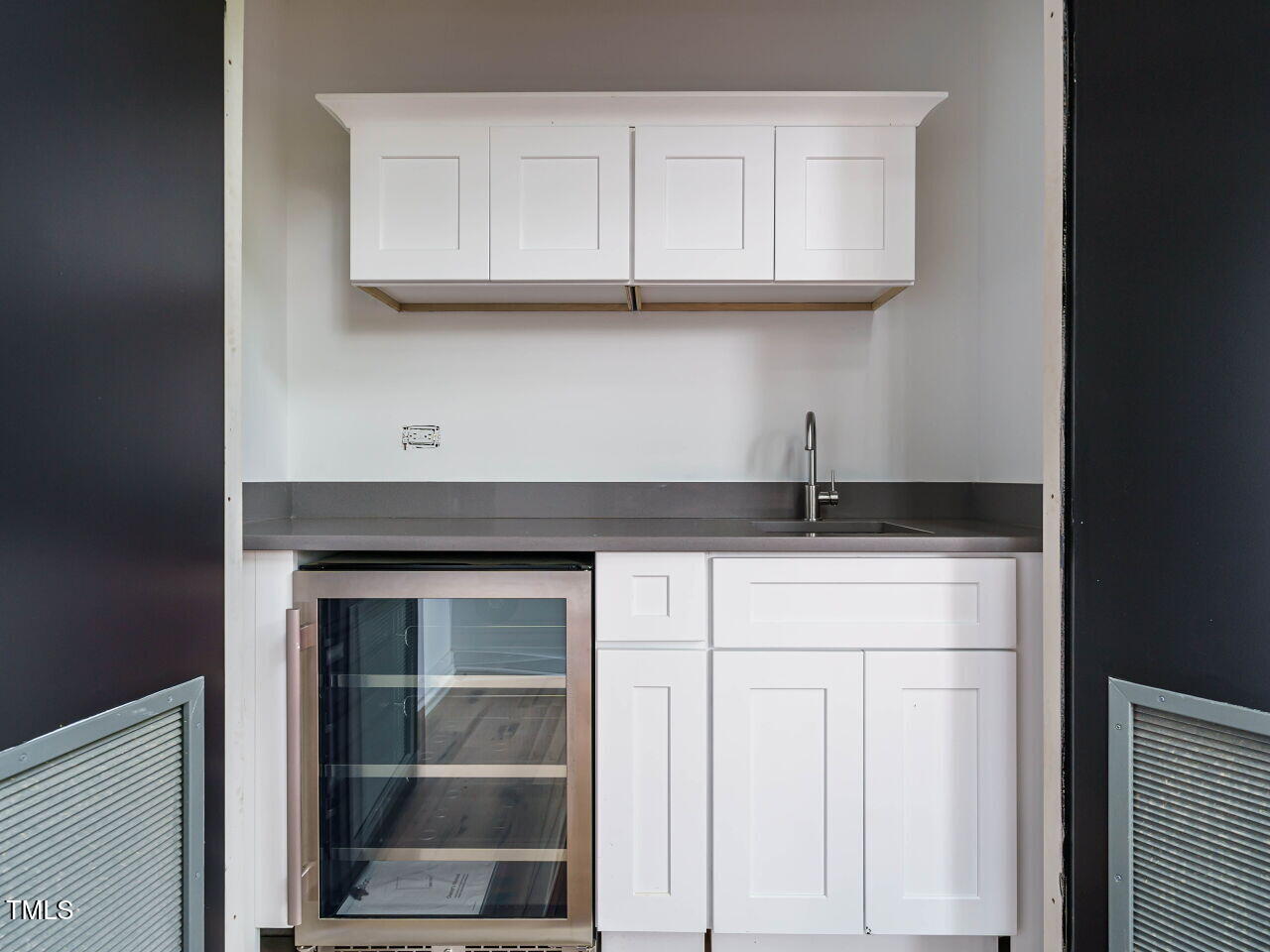 1521 Havenmont Court Raleigh, NC 27608 - Photo 29 of 36 a kitchen with white cabinets and a sink