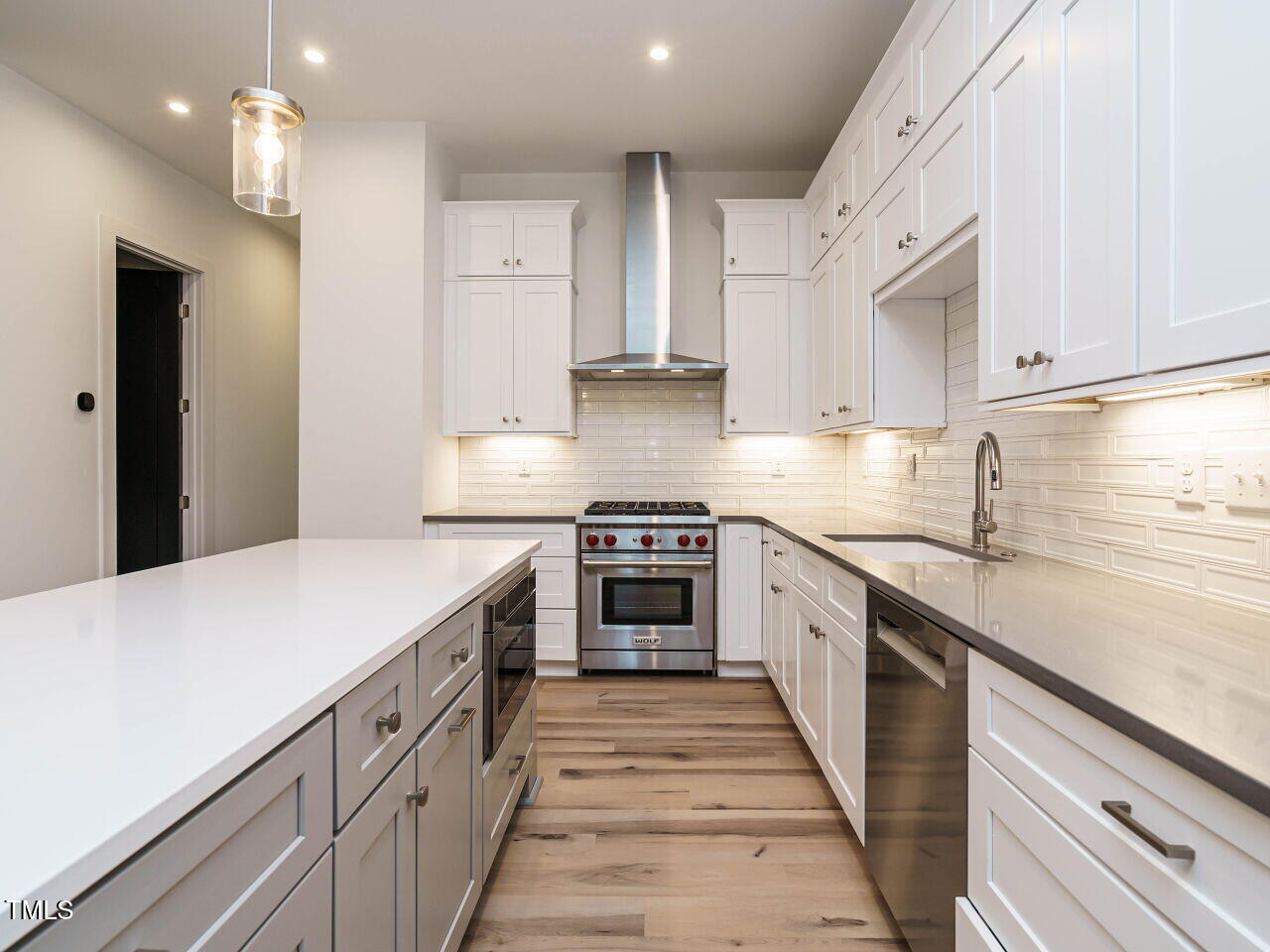 1521 Havenmont Court Raleigh, NC 27608 - Photo 3 of 36 a kitchen with stainless steel appliances granite countertop a stove and a sink
