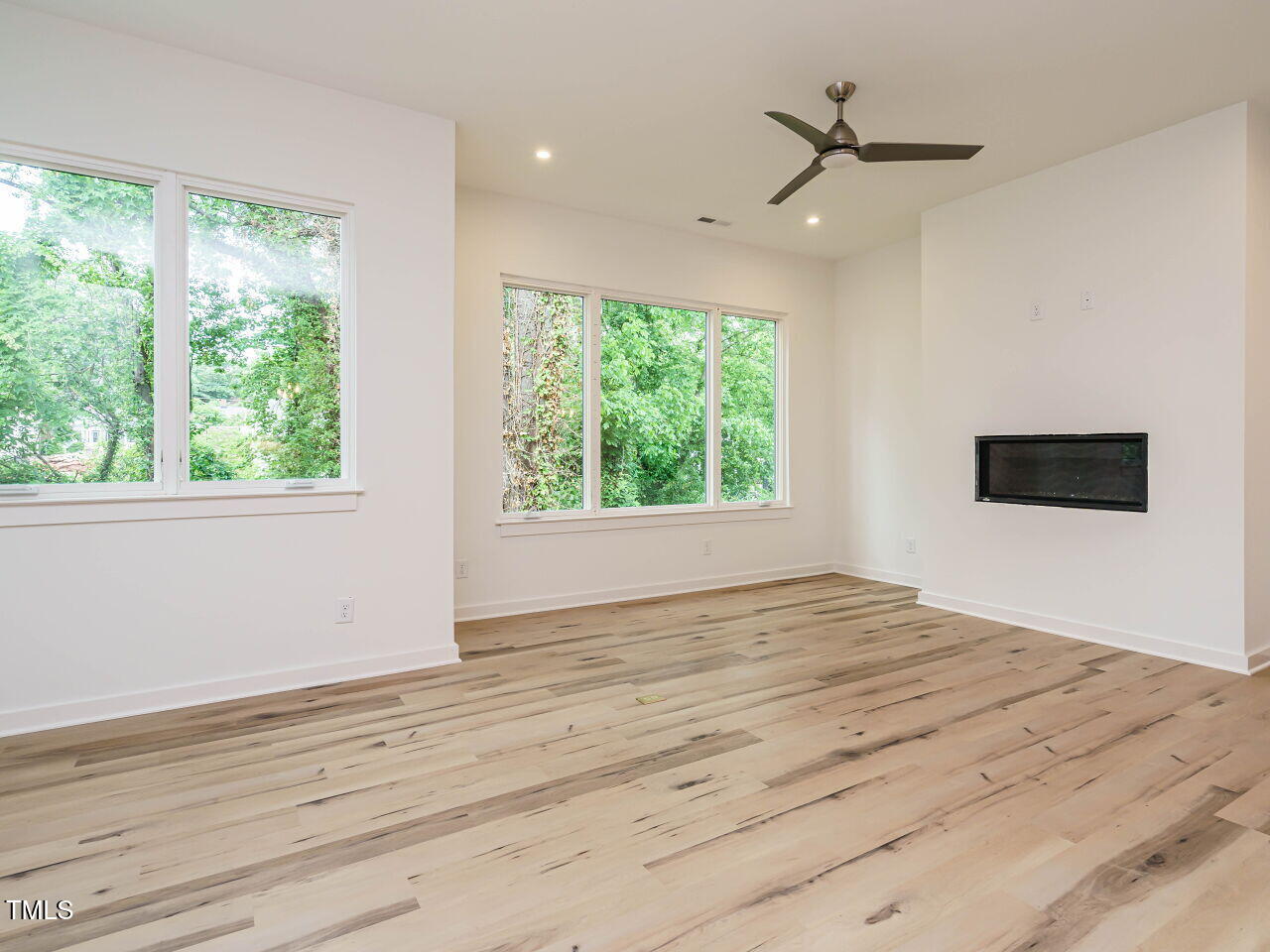 1521 Havenmont Court Raleigh, NC 27608 - Photo 6 of 36 a view of an empty room with wooden floor and a window