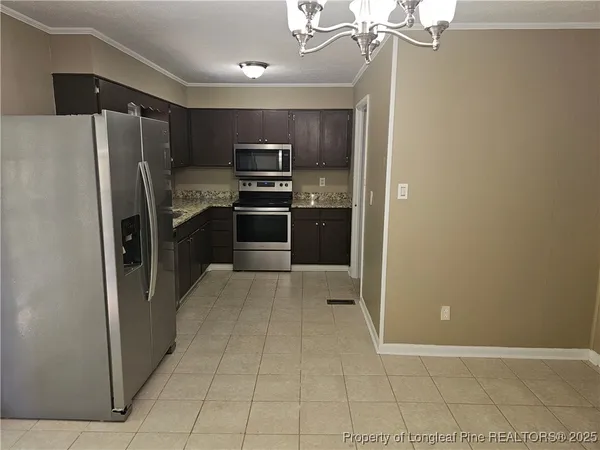 a kitchen with stainless steel appliances a refrigerator and a stove