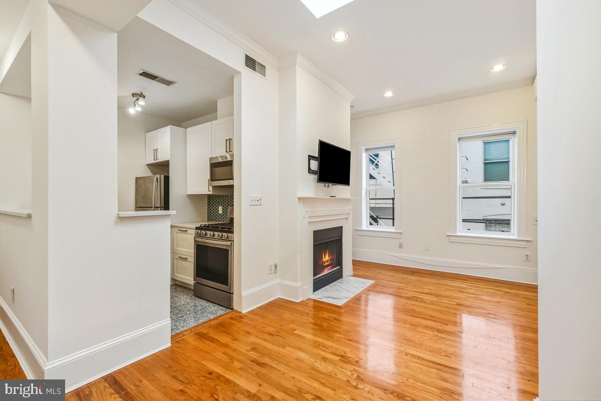 1807 California Street Northwest, Unit 305 Washington, DC 20009 - Photo 12 of 30 a bedroom with a bed and a television