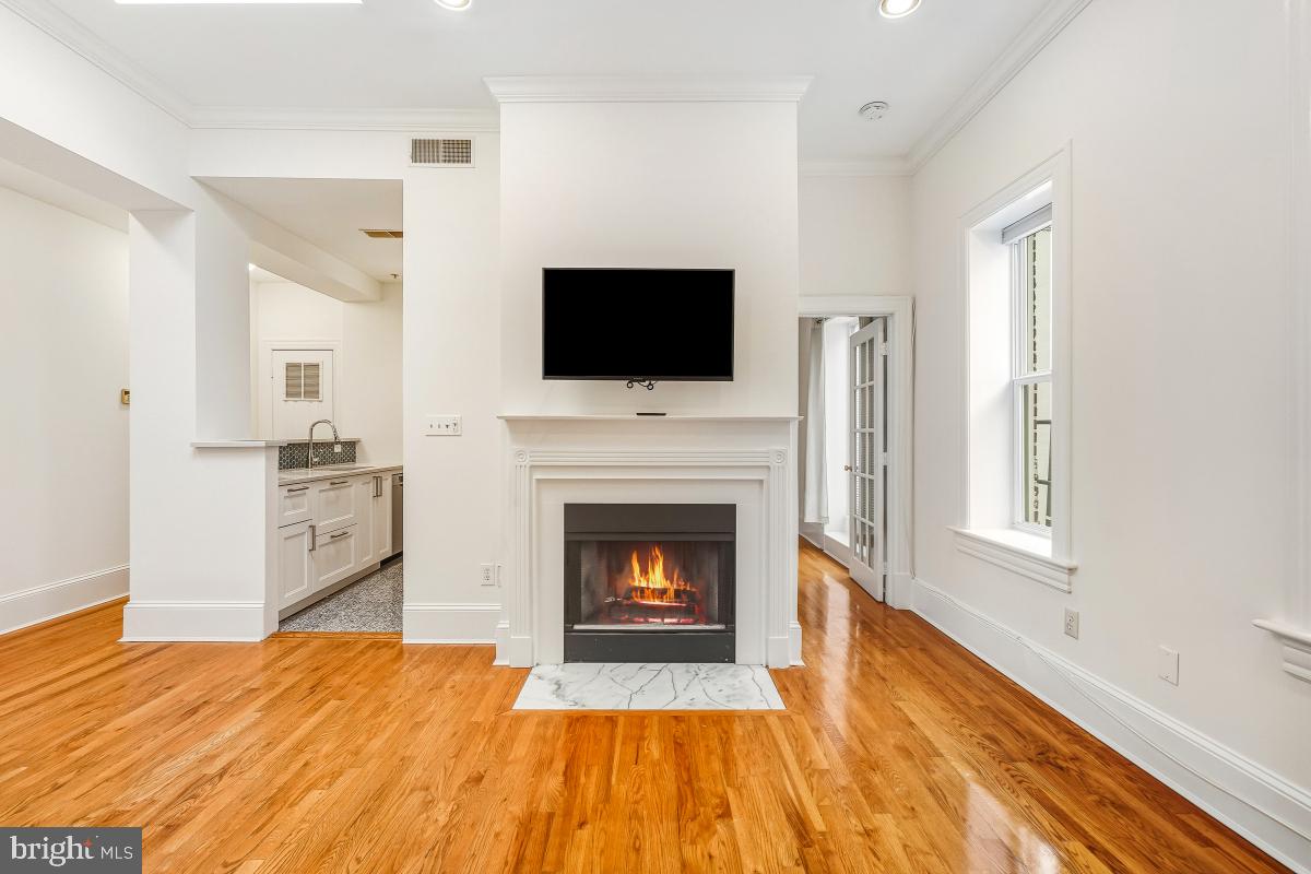 1807 California Street Northwest, Unit 305 Washington, DC 20009 - Photo 14 of 30 a living room with a fireplace and a flat screen tv