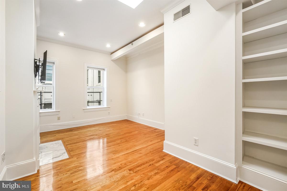 1807 California Street Northwest, Unit 305 Washington, DC 20009 - Photo 16 of 30 a view of empty room with window and wooden floor