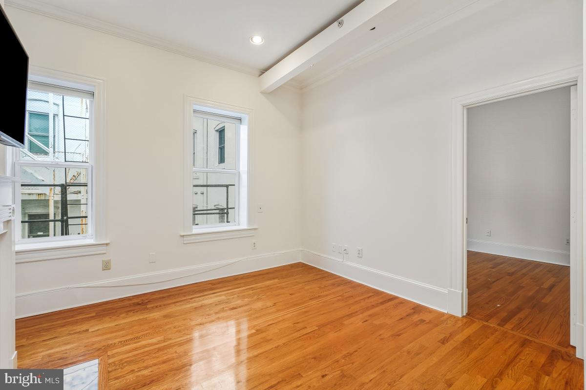 1807 California Street Northwest, Unit 305 Washington, DC 20009 - Photo 18 of 30 a view of empty room with wooden floor and fan