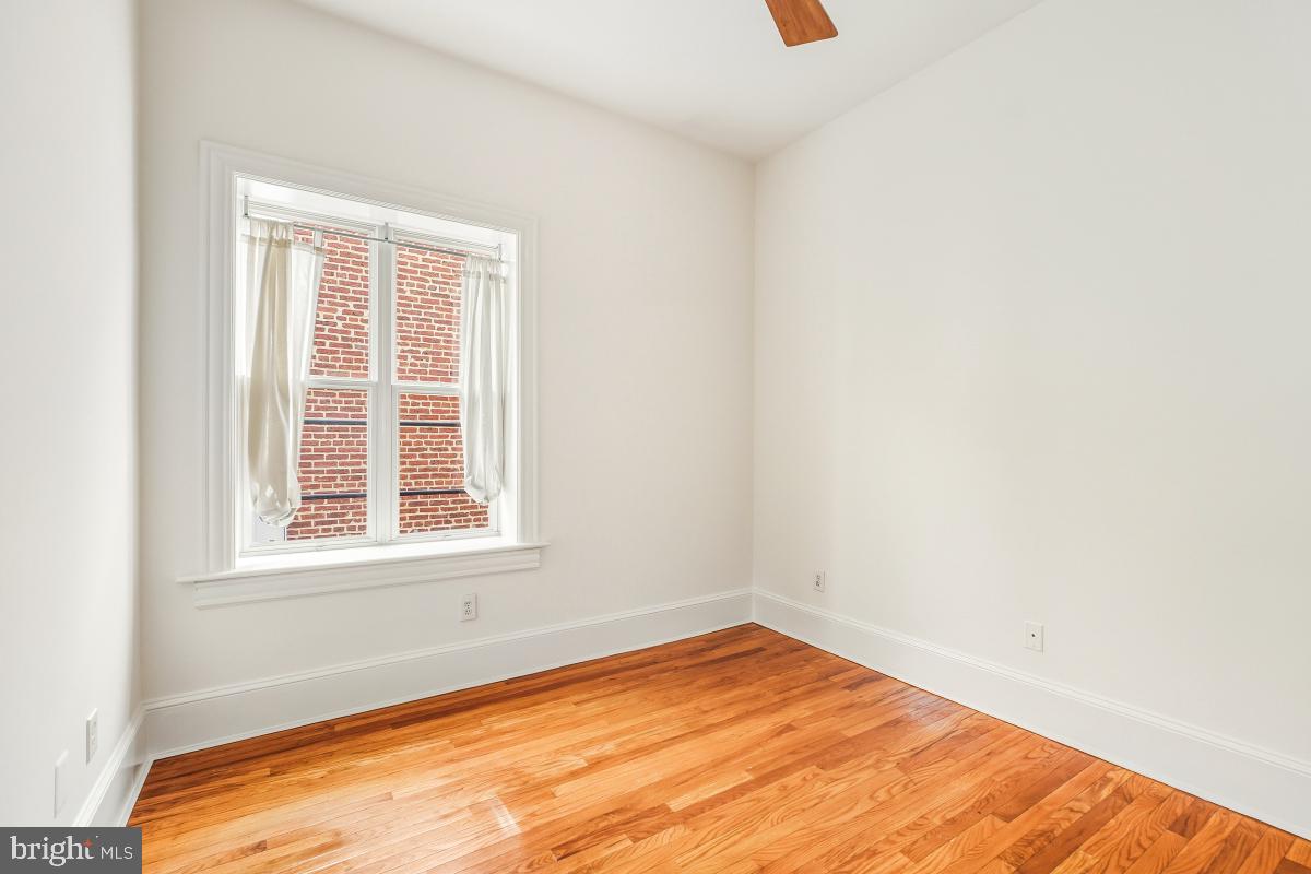 1807 California Street Northwest, Unit 305 Washington, DC 20009 - Photo 26 of 30 a view of empty room with wooden floor and fan