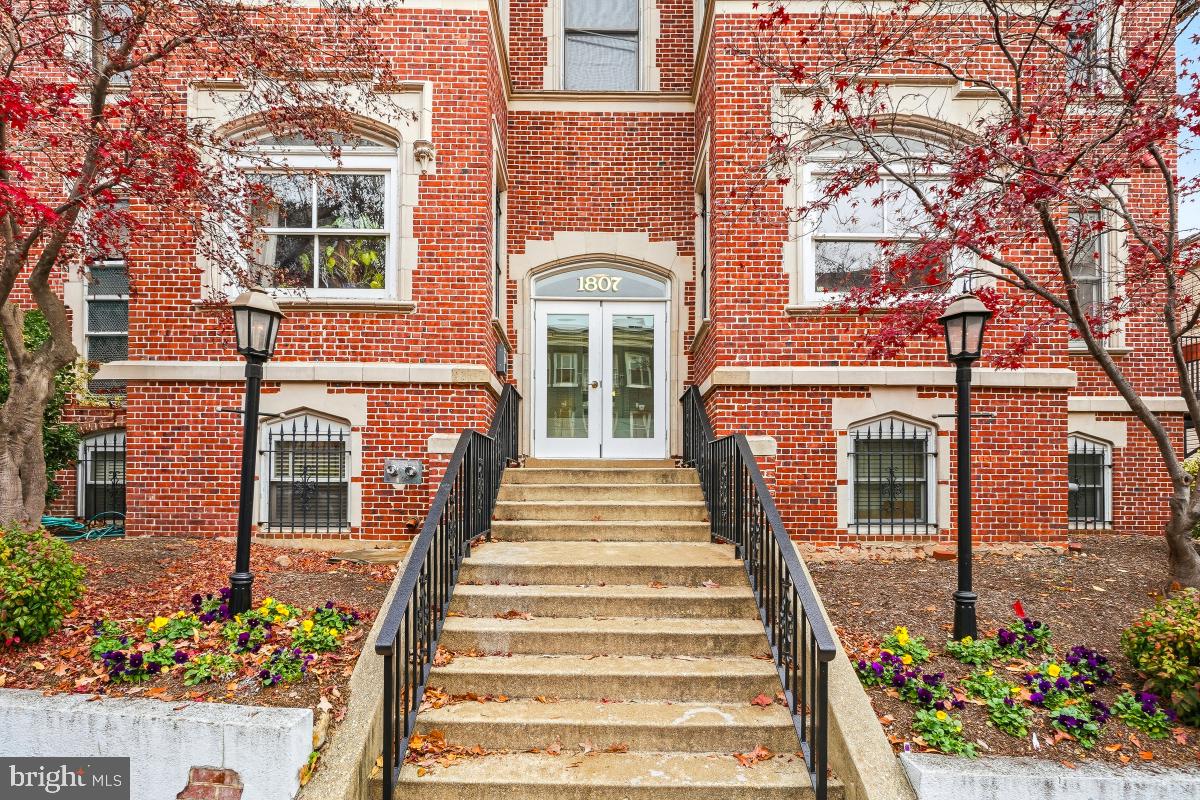 1807 California Street Northwest, Unit 305 Washington, DC 20009 - Photo 3 of 30 a front view of a multi story residential apartment building with a garden