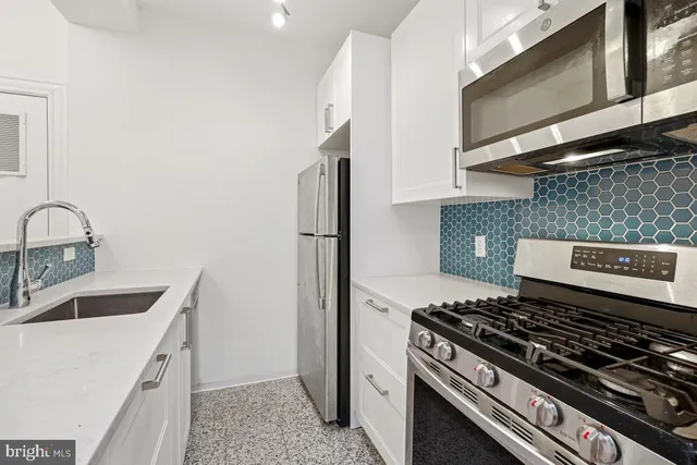 a kitchen that has a sink and a stove