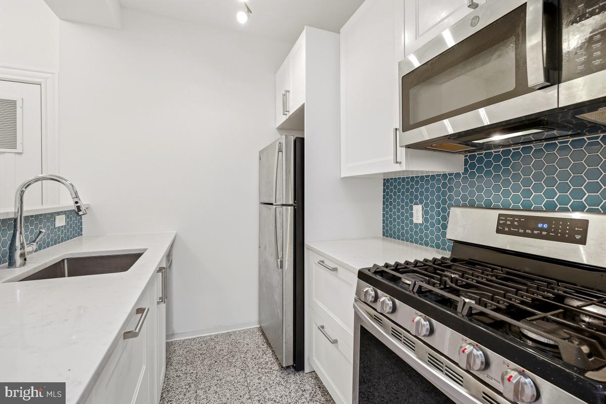 1807 California Street Northwest, Unit 305 Washington, DC 20009 - Photo 9 of 30 a kitchen with a stove and a sink