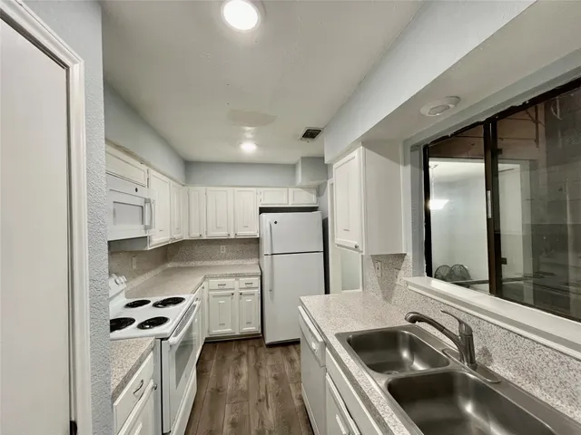 a kitchen with a refrigerator sink and stove