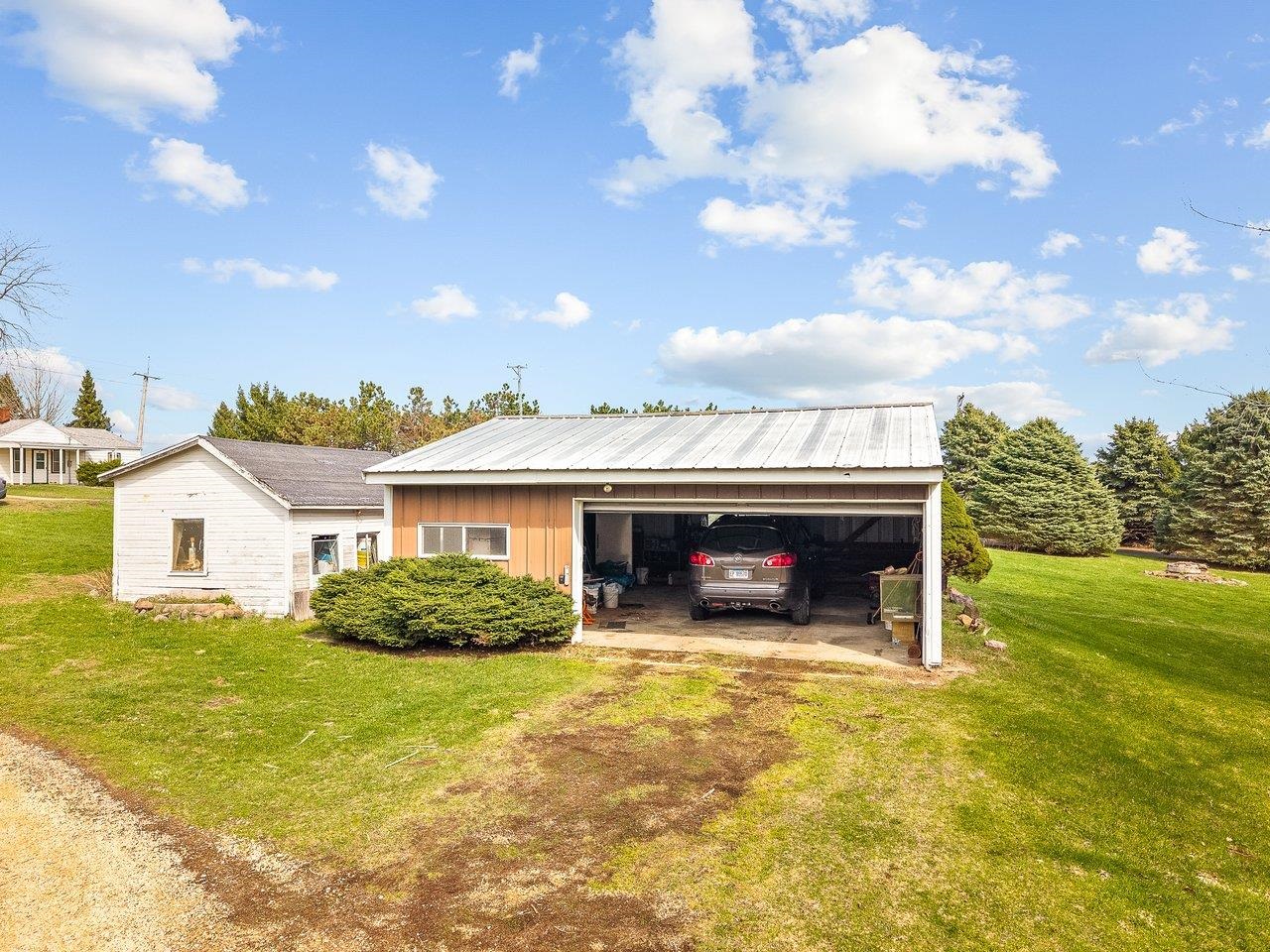2280 South Rock City Road Ridott, IL 61067 - Photo 57 of 59 a view of a house with a patio and a yard