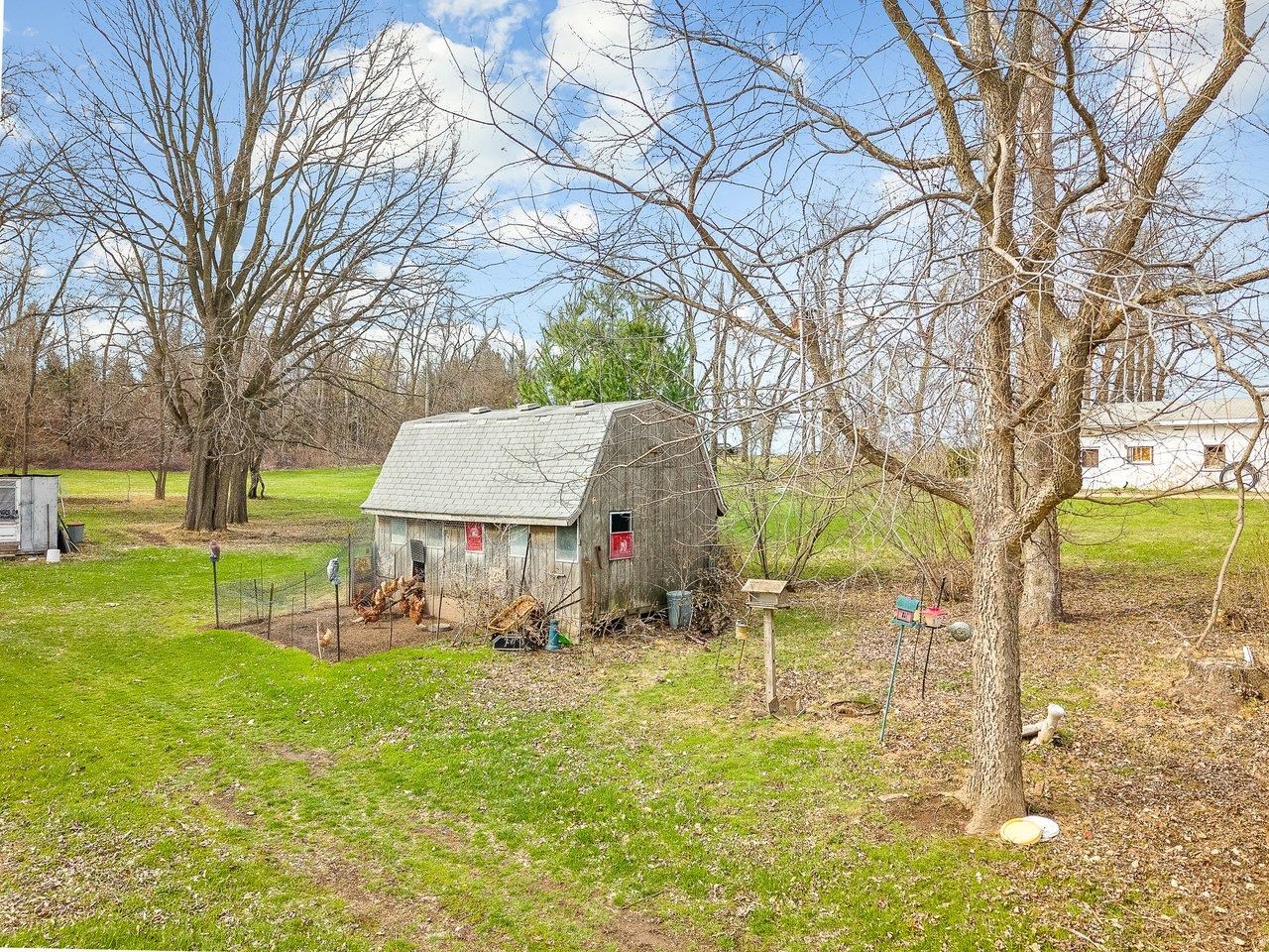 2280 South Rock City Road Ridott, IL 61067 - Photo 58 of 59 a view of backyard with wooden fence and large trees
