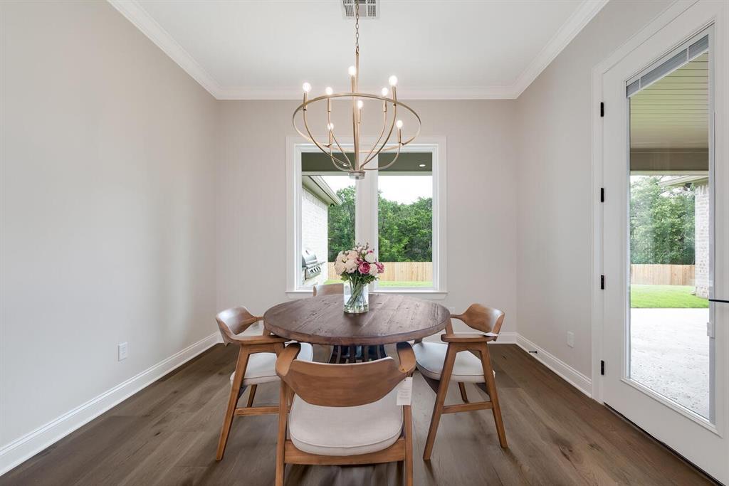 8005 Bee Cave Road China Spring, TX 76633 - Photo 20 of 40 a dining room with furniture a chandelier and wooden floor
