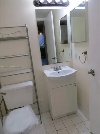 a bathroom with a sink toilet and mirror