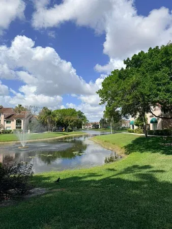 a view of a lake with houses in the background