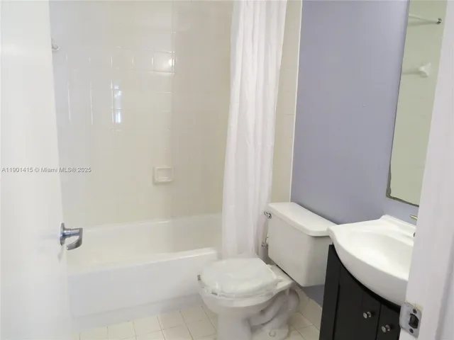 a white toilet sitting next to a bath tub