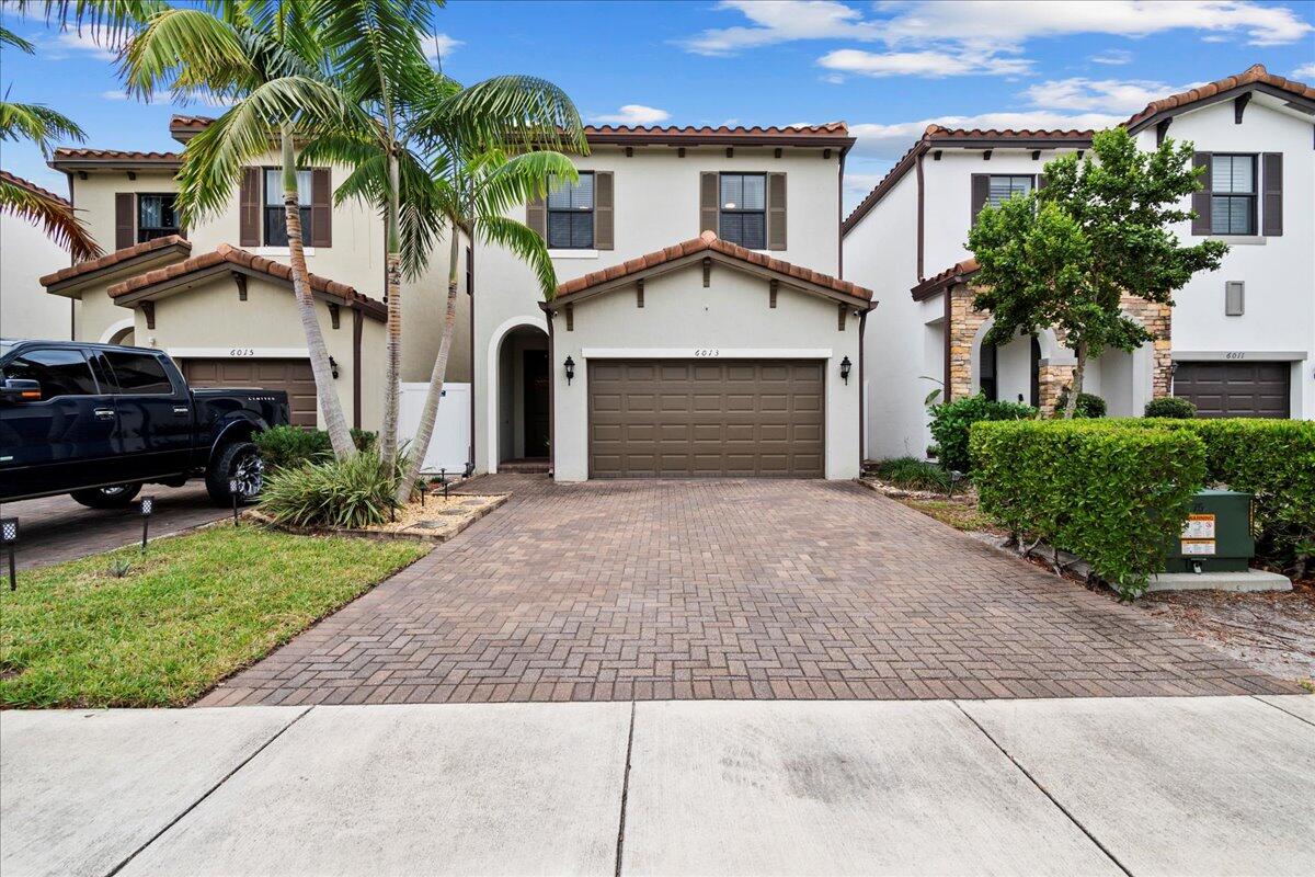 6013 Pine Tree Way Riviera Beach, FL 33410 - Photo 1 of 33 front view of a house with a yard