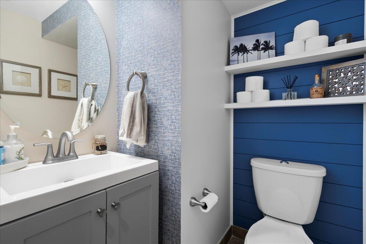 6013 Pine Tree Way Riviera Beach, FL 33410 - Photo 12 of 33 a bathroom with a toilet sink and mirror