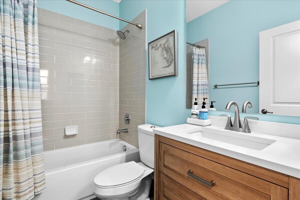 6013 Pine Tree Way Riviera Beach, FL 33410 - Photo 18 of 33 a bathroom with a sink a toilet and a bathtub