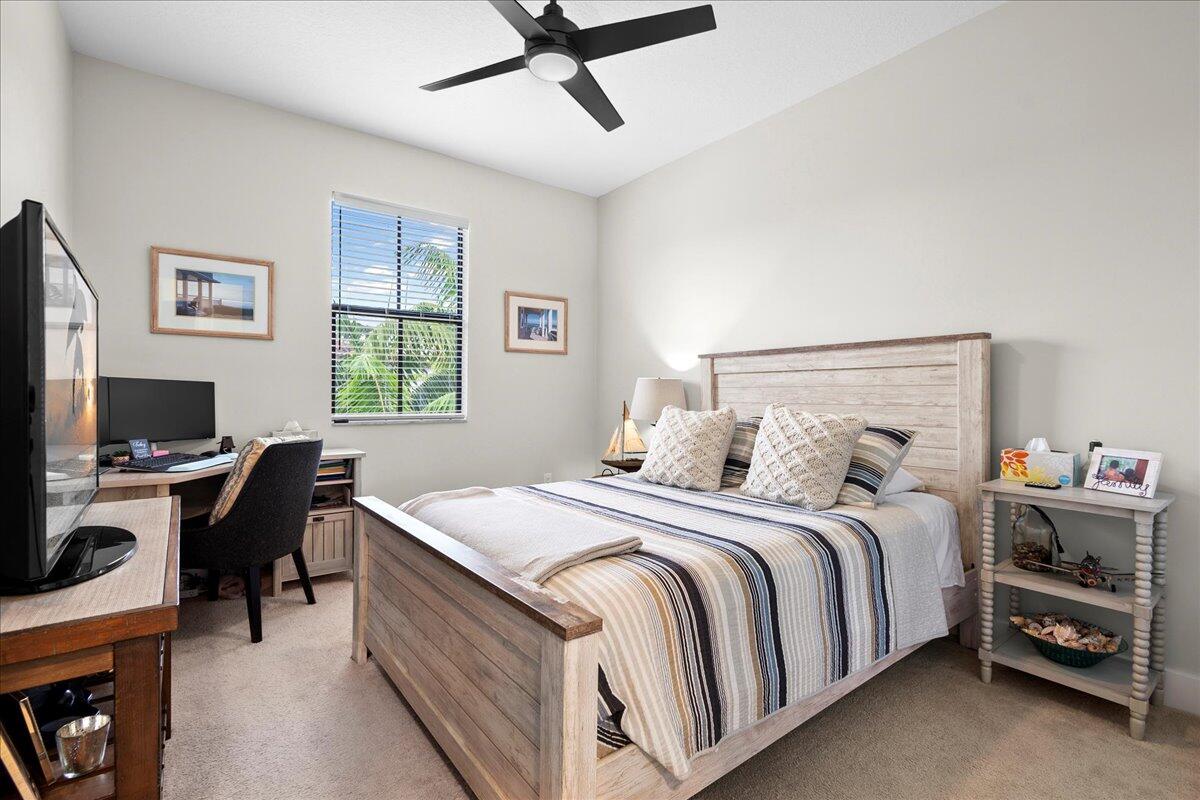 6013 Pine Tree Way Riviera Beach, FL 33410 - Photo 19 of 33 a bedroom with a bed and a desk